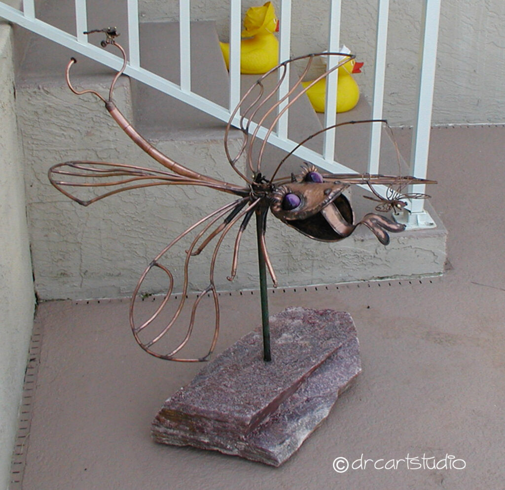 A photo of a handmade copper dragonfly