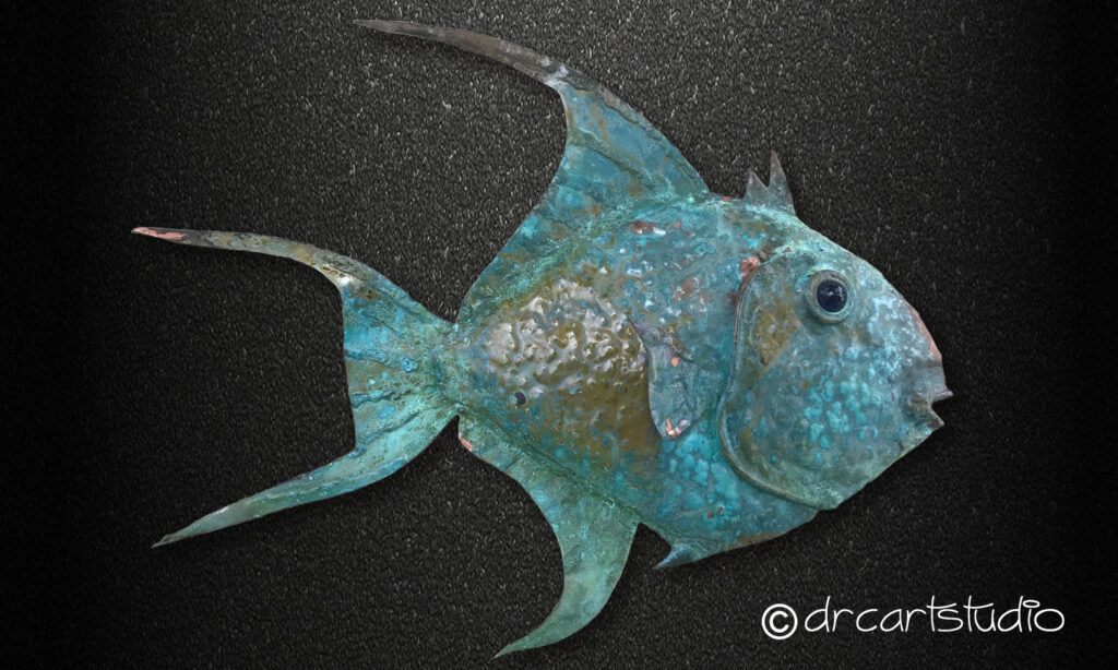 A photo of a hand made copper fish