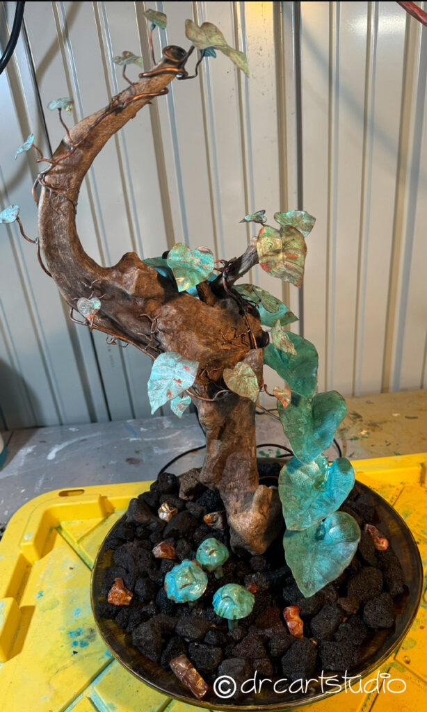 A photo of a hand made fountain made of copper