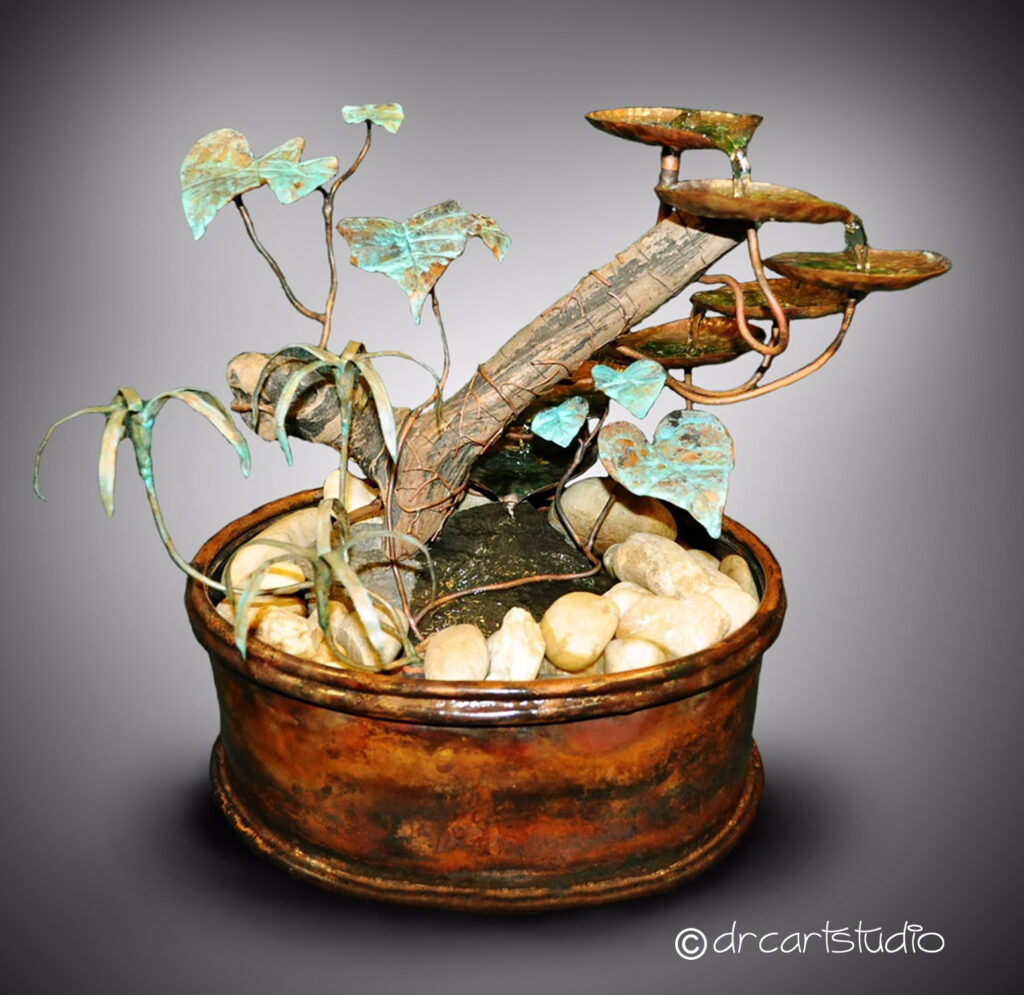 A photo of a hand made fountain made of copper