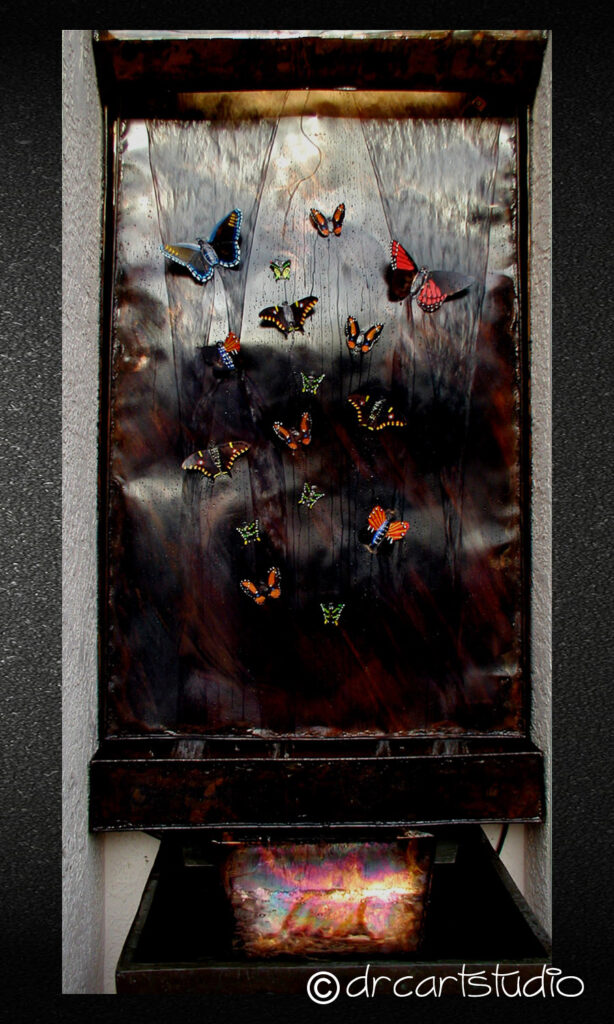 Photo of a hand made copper wall mounted fountain with copper butterflies