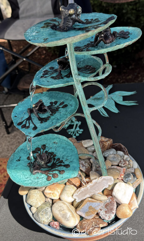 Photo of a hand made copper fountain with copper frogs
