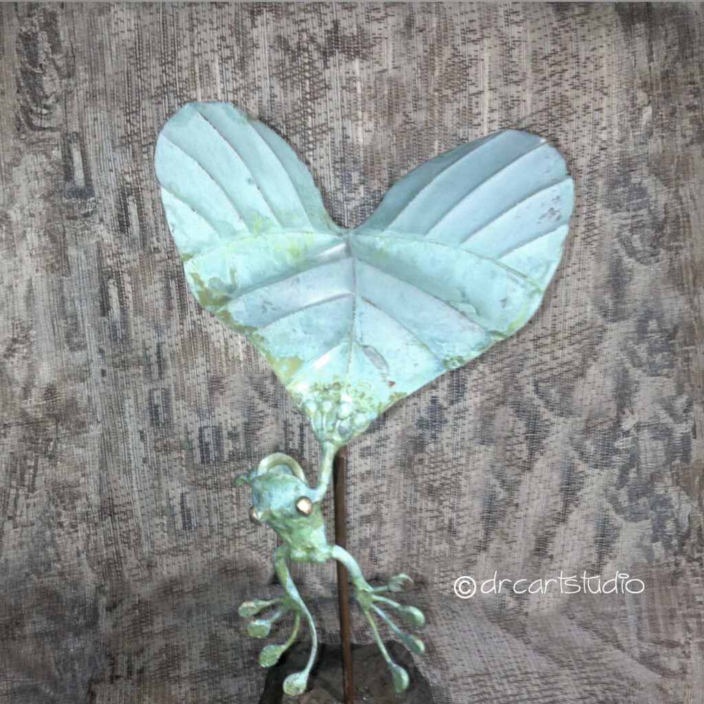 Photo of a hand-made copper frog...hanging on